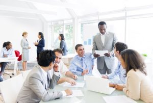 Group of employees working on a rebranding strategy in an office.